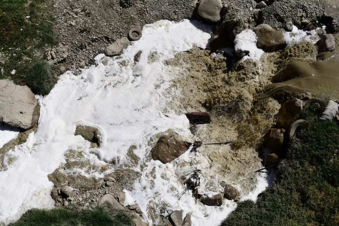 Cauce del río La Paz en una vista aérea, evidencia la contaminación del agua por su color turbio y espuma.
